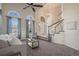Bright living room boasting large arched windows, staircase and comfortable seating at 853 Huntington Dr, Highlands Ranch, CO 80126