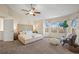 Bright main bedroom with vaulted ceilings, large windows, and a king-sized bed at 853 Huntington Dr, Highlands Ranch, CO 80126