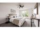 Bright bedroom with neutral tones, large window, ceiling fan, and carpet floors at 9316 W Utah Ave, Lakewood, CO 80232