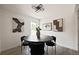 Bright dining area featuring modern lighting, sleek black table and chairs, and contemporary art at 9316 W Utah Ave, Lakewood, CO 80232