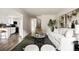 Bright living room with modern furnishings, an open floor plan, and seamless flow to the kitchen at 9316 W Utah Ave, Lakewood, CO 80232