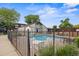 Community pool surrounded by black fencing and lounge chairs at 9316 W Utah Ave, Lakewood, CO 80232