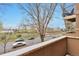 Balcony view of street with mature trees and cars below in residential area at 2686 S Cherokee St, Denver, CO 80223