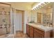 Bathroom features double sinks, granite countertop, tile shower, and neutral colored walls at 2686 S Cherokee St, Denver, CO 80223