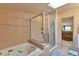 Bright bathroom featuring a jacuzzi tub and enclosed glass shower with tile surround at 2686 S Cherokee St, Denver, CO 80223