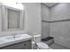 Updated bathroom featuring gray vanity and modern tiled walk-in shower with bench at 2686 S Cherokee St, Denver, CO 80223