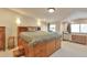 Spacious bedroom with built-in storage bed, neutral walls, and carpet flooring at 2686 S Cherokee St, Denver, CO 80223