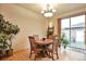 Charming dining area with a wooden table, chandelier lighting, and sliding glass door at 2686 S Cherokee St, Denver, CO 80223