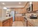 Modern kitchen with stainless steel appliances, granite countertops, and ample cabinet space at 2686 S Cherokee St, Denver, CO 80223
