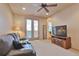 Comfortable living room with French doors, a television, and neutral colored walls at 2686 S Cherokee St, Denver, CO 80223