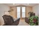 Cozy living area with french doors, comfortable chairs and indoor plants at 2686 S Cherokee St, Denver, CO 80223