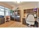 Bright home office featuring custom built-ins, hardwood flooring, and ample natural light at 2686 S Cherokee St, Denver, CO 80223