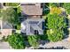 Aerial view of house featuring solar panels on the roof, surrounded by lush greenery in a neighborhood setting at 2692 N Raleigh St, Denver, CO 80212