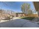 Well-kept backyard featuring a concrete patio, outdoor seating, and a wooden fence with a patch of grass at 2692 N Raleigh St, Denver, CO 80212