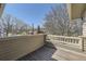 A cozy outdoor balcony offering a peaceful view of the neighborhood and the blue skies above at 2692 N Raleigh St, Denver, CO 80212