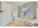 Bathroom featuring marble floors, soaking tub, and modern fixtures at 2692 N Raleigh St, Denver, CO 80212