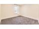 Bright bedroom featuring neutral walls and flooring, complemented by a single window with natural light at 2692 N Raleigh St, Denver, CO 80212