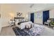 Bright, spacious bedroom with a plush bed, stylish seating, a ceiling fan, and ample natural light from large windows at 2692 N Raleigh St, Denver, CO 80212