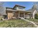 Charming brick home with a welcoming front porch and well-maintained lawn at 2692 N Raleigh St, Denver, CO 80212