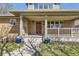 Charming covered front porch with brick columns and cozy seating area at 2692 N Raleigh St, Denver, CO 80212