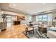 Bright living room featuring hardwood floors, an open floor plan, and large windows with plenty of natural light at 2692 N Raleigh St, Denver, CO 80212