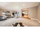 Spacious living room with plush carpet, neutral paint, and large windows for plenty of natural light at 2692 N Raleigh St, Denver, CO 80212
