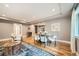Open-concept living room featuring hardwood floors, a stylish dining area, and plenty of space for entertaining guests at 2692 N Raleigh St, Denver, CO 80212