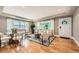 Sun-drenched living room boasting hardwood floors, modern decor, and expansive windows overlooking the outdoors at 2692 N Raleigh St, Denver, CO 80212