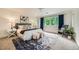 Bright main bedroom featuring soft carpet, bright windows, and stylish furnishings at 2692 N Raleigh St, Denver, CO 80212