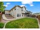 Expansive backyard featuring a lush lawn, deck, patio, and convenient access ramp at 9856 Keenan St, Highlands Ranch, CO 80130