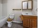 Charming bathroom with wood vanity, modern fixtures, bathtub, and wood-look vinyl flooring at 9856 Keenan St, Highlands Ranch, CO 80130