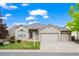 Charming single-Gathering home showcasing a well-manicured lawn and a spacious two-car garage at 9856 Keenan St, Highlands Ranch, CO 80130
