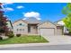 Charming single-Gathering home showcasing a well-manicured lawn and a spacious two-car garage at 9856 Keenan St, Highlands Ranch, CO 80130