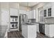 Well-equipped kitchen featuring modern stainless steel appliances and pristine white cabinets at 9856 Keenan St, Highlands Ranch, CO 80130
