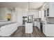 Modern kitchen with granite counters, white cabinets, and stainless steel appliances at 9856 Keenan St, Highlands Ranch, CO 80130