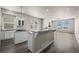 Spacious kitchen featuring granite countertops, modern appliances, with dark hardwood floors at 9856 Keenan St, Highlands Ranch, CO 80130