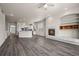 Spacious living area with fireplace, built-in shelving, and an open layout to the kitchen at 9856 Keenan St, Highlands Ranch, CO 80130