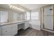 The main bathroom has a double vanity, granite countertop, soaking tub, and glass enclosed shower at 9856 Keenan St, Highlands Ranch, CO 80130