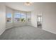 Bright main bedroom with bay window, plush carpet, neutral walls, and ensuite bathroom access at 9856 Keenan St, Highlands Ranch, CO 80130