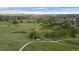 Scenic aerial view of a park with winding trails surrounded by greenery and homes at 9856 Keenan St, Highlands Ranch, CO 80130