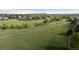 Scenic view of a neighborhood park with walking paths, grassy fields, and lush greenery for recreation and relaxation at 9856 Keenan St, Highlands Ranch, CO 80130