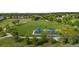 A spacious park with a playground, green grass and walking paths, perfect for outdoor activities and enjoying nature at 9856 Keenan St, Highlands Ranch, CO 80130