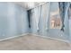 Comfortable carpeted bedroom with light-blue walls and decorative curtains framing the window at 14301 E Tennessee Ave # 109, Aurora, CO 80012