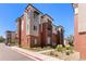 Stylish condo exterior with brick accents, balconies, and well-maintained landscaping at 14301 E Tennessee Ave # 109, Aurora, CO 80012