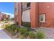 Image showcasing the building exterior with red brick and a small garden area at 14301 E Tennessee Ave # 109, Aurora, CO 80012