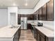 Spacious kitchen with stainless appliances, extensive counter space, and modern dark wood cabinets at 14301 E Tennessee Ave # 109, Aurora, CO 80012