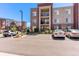 Exterior shot showing the building's parking lot with allocated parking spots for residents and guests at 14301 E Tennessee Ave # 109, Aurora, CO 80012