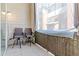 Cozy balcony with tiled flooring and two bar-height chairs with views of the surrounding buildings at 14301 E Tennessee Ave # 109, Aurora, CO 80012