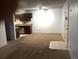 Spacious living room with carpet, tile entry, a ceiling fan, and access to the kitchen at 16359 W 10Th Ave # 1, Golden, CO 80401