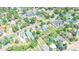 An aerial view captures the property's setting within a neighborhood, showcasing tree-lined streets and nearby houses at 2294 W Parkhill Ave, Littleton, CO 80120